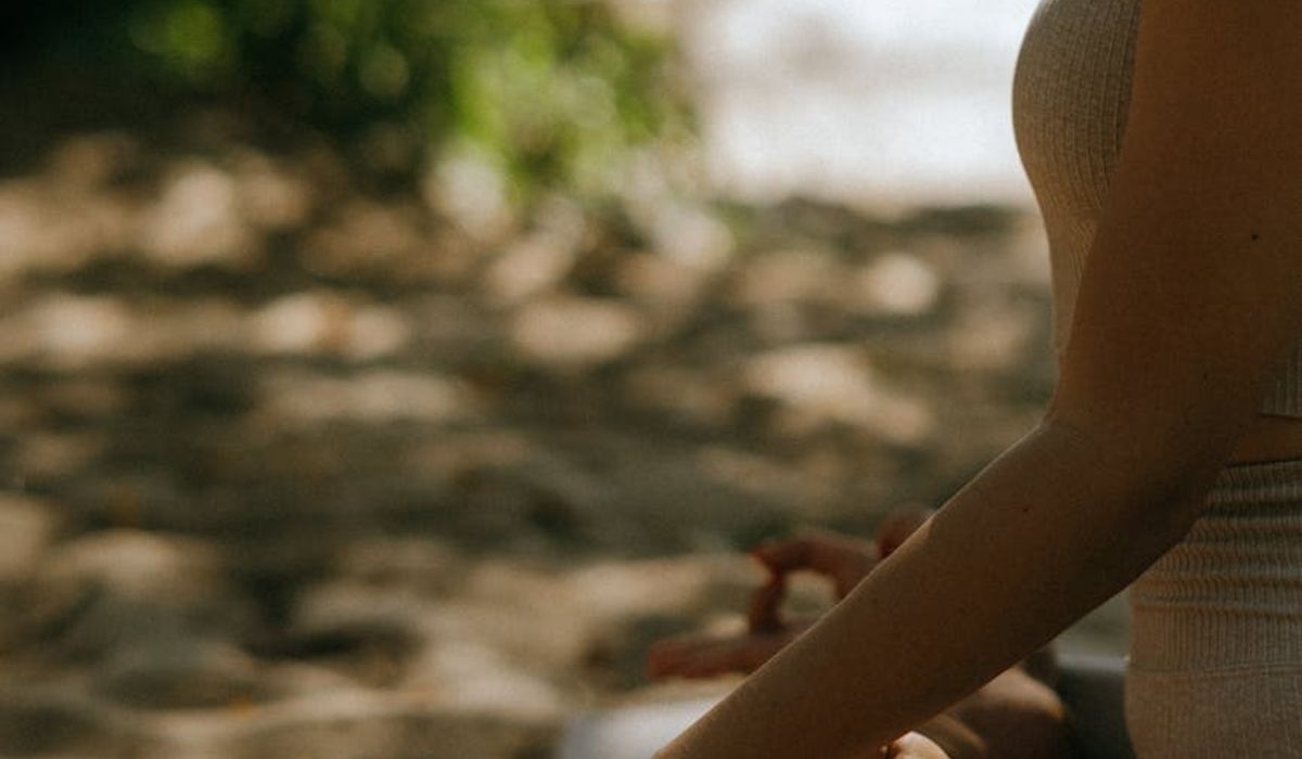 Person practicing mindfulness meditation in serene modern environment
